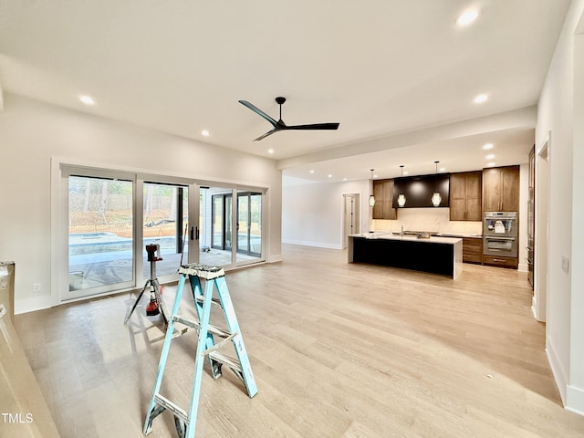 living room with light hardwood / wood-style flooring and ceiling fan