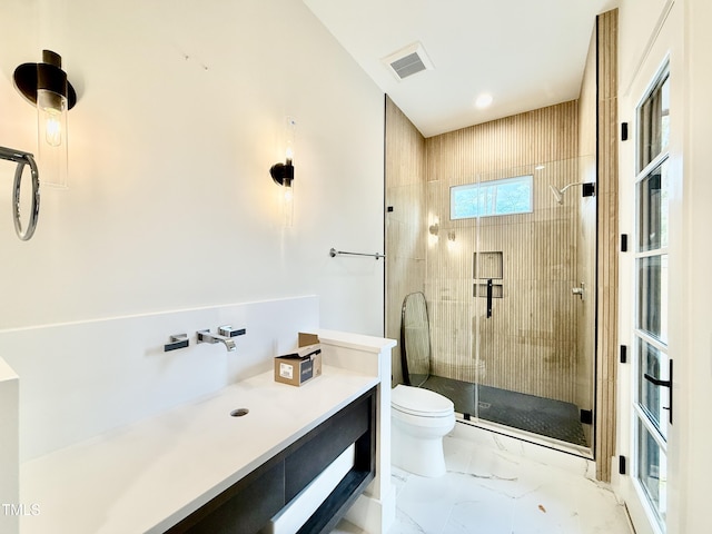 bathroom featuring toilet and walk in shower