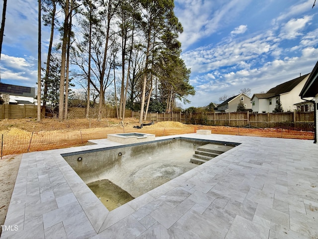 view of swimming pool with a patio area, a fenced backyard, and an in ground hot tub