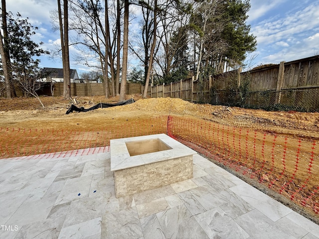 view of yard with a patio area, a fire pit, and a fenced backyard