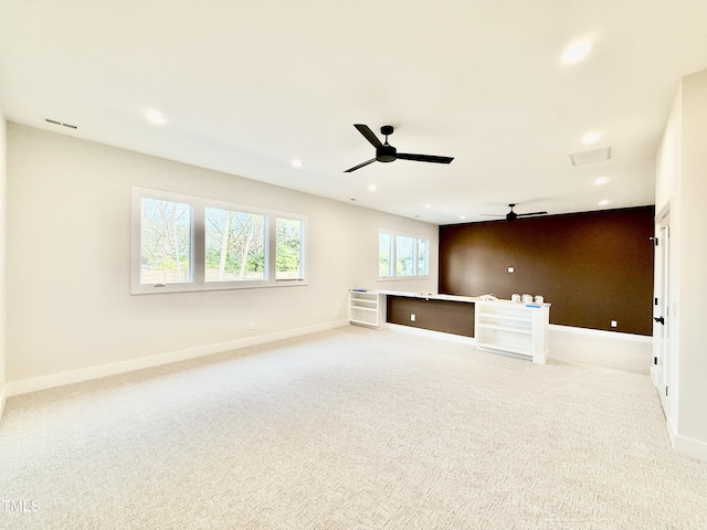 unfurnished living room with ceiling fan and light carpet