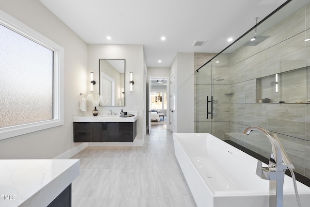 full bathroom with visible vents, a soaking tub, vanity, a shower stall, and recessed lighting