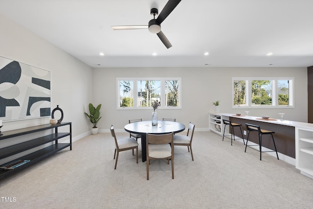 dining area featuring a ceiling fan, recessed lighting, light carpet, and baseboards