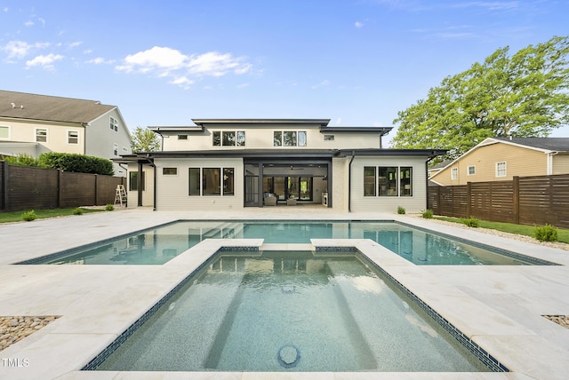 662 Manchester Dr, Raleigh, NC 27609 - rear view of property featuring a pool with connected hot tub, a fenced backyard, and a patio area
