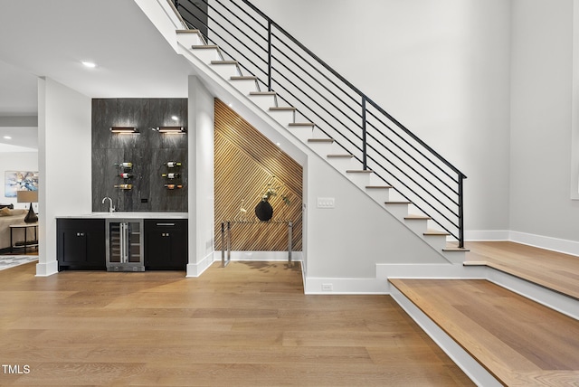 662 Manchester Dr, Raleigh, NC 27609 - indoor bar with wine cooler, light wood-type flooring, stairway, and recessed lighting