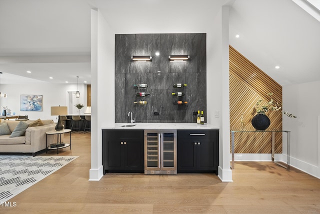 662 Manchester Dr, Raleigh, NC 27609 - indoor wet bar featuring beverage cooler, light wood-type flooring, recessed lighting, and baseboards
