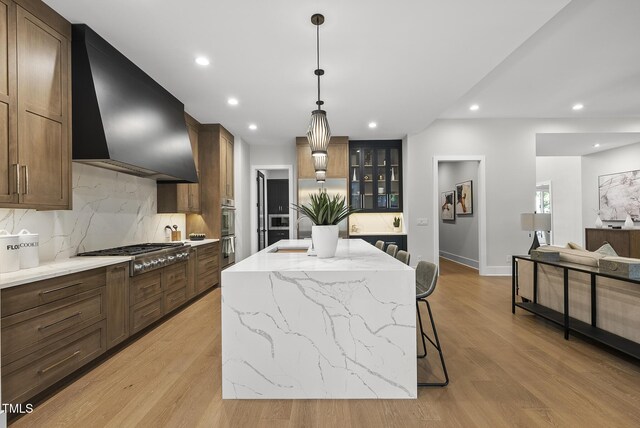662 Manchester Dr, Raleigh, NC 27609 - kitchen with wall chimney range hood, stainless steel appliances, a sink, decorative backsplash, and recessed lighting