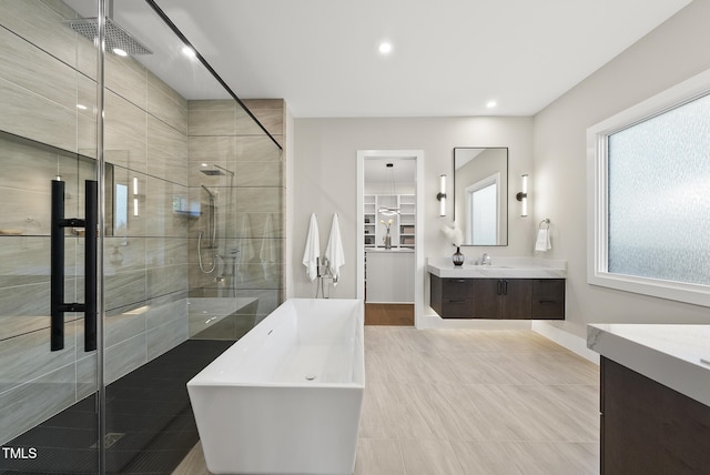 662 Manchester Dr, Raleigh, NC 27609 - full bathroom featuring a stall shower, vanity, a freestanding bath, and recessed lighting