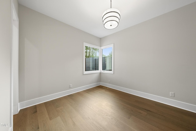 662 Manchester Dr, Raleigh, NC 27609 - unfurnished room with dark wood-type flooring and baseboards