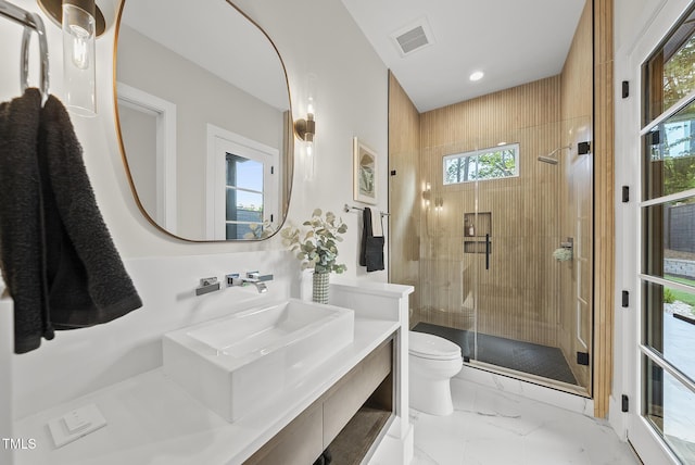 662 Manchester Dr, Raleigh, NC 27609 - bathroom with toilet, marble finish flooring, a shower stall, plenty of natural light, and recessed lighting