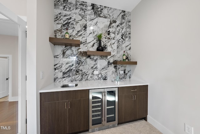 662 Manchester Dr, Raleigh, NC 27609 - indoor wet bar with wine cooler, decorative backsplash, and baseboards