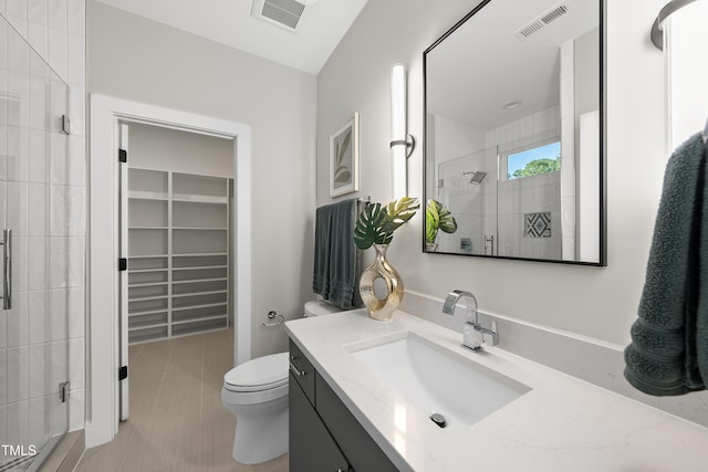 662 Manchester Dr, Raleigh, NC 27609 - bathroom with a shower stall, toilet, a spacious closet, tile patterned flooring, and vanity