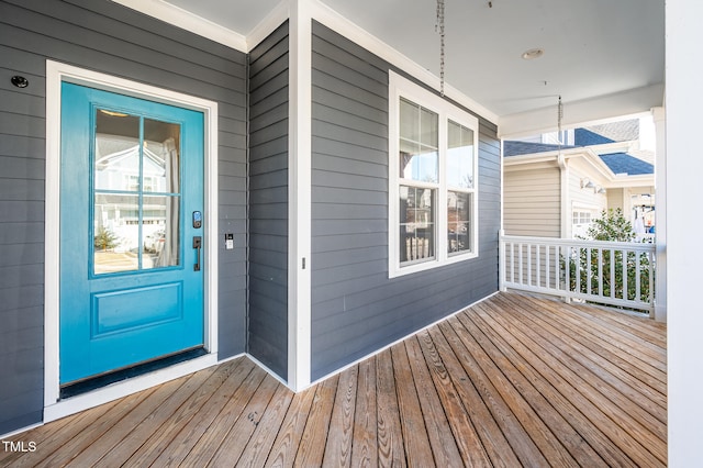 view of exterior entry featuring covered porch