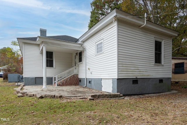 rear view of house with a patio area and a yard