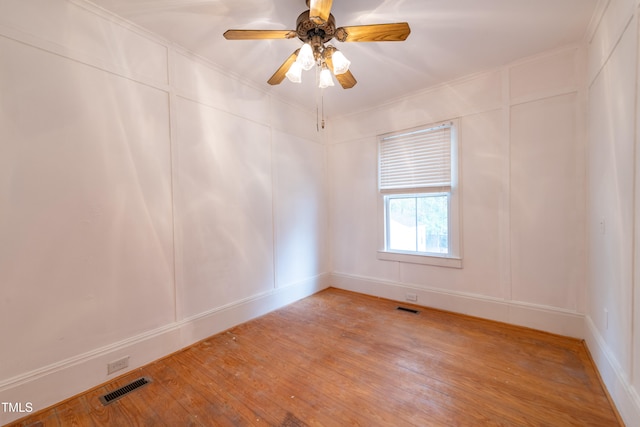 unfurnished room with ornamental molding, hardwood / wood-style flooring, and ceiling fan