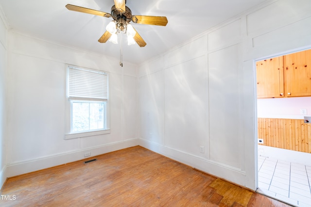 spare room with light wood-type flooring and ceiling fan