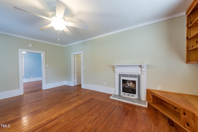 unfurnished living room with hardwood / wood-style floors, crown molding, and ceiling fan