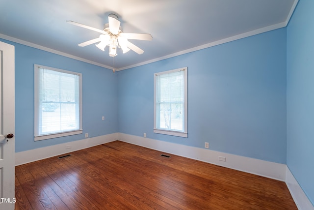 empty room with ornamental molding, hardwood / wood-style floors, and ceiling fan