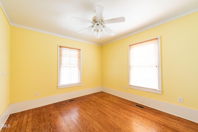 spare room featuring ornamental molding, hardwood / wood-style floors, and ceiling fan