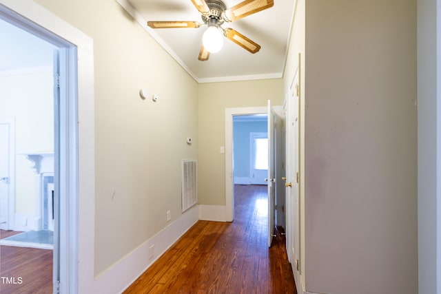 hallway featuring crown molding and dark wood-type flooring