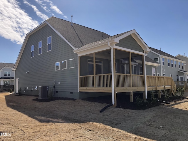 back of house featuring roof with shingles, crawl space, a sunroom, and central air condition unit