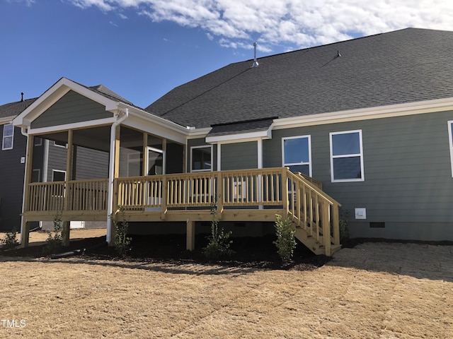 back of house featuring a shingled roof, crawl space, and a sunroom