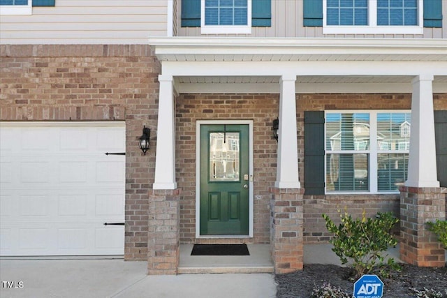 doorway to property with a garage