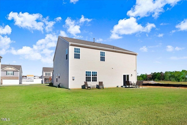 rear view of house with a patio and a lawn