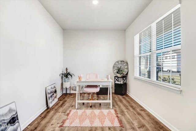 office space with wood-type flooring