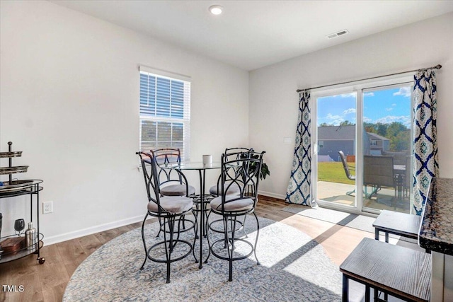 dining room with hardwood / wood-style flooring and plenty of natural light