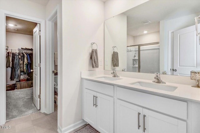 bathroom featuring vanity and an enclosed shower