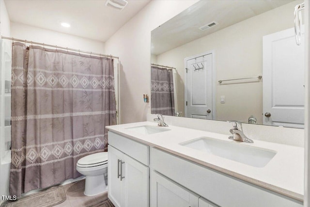 full bathroom with vanity, toilet, tile patterned floors, and shower / tub combo