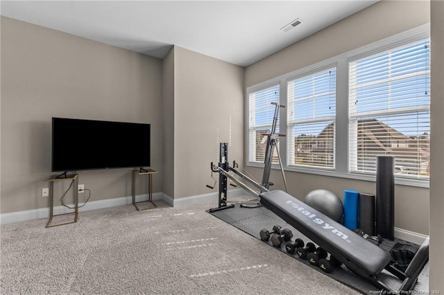 exercise room with visible vents, carpet floors, and baseboards