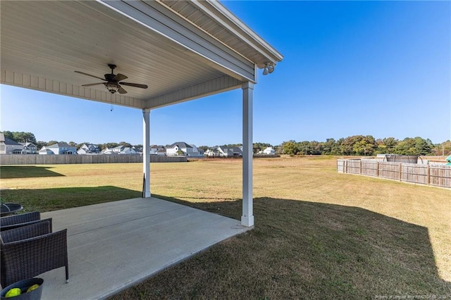 view of yard featuring a ceiling fan, fence, and a patio area