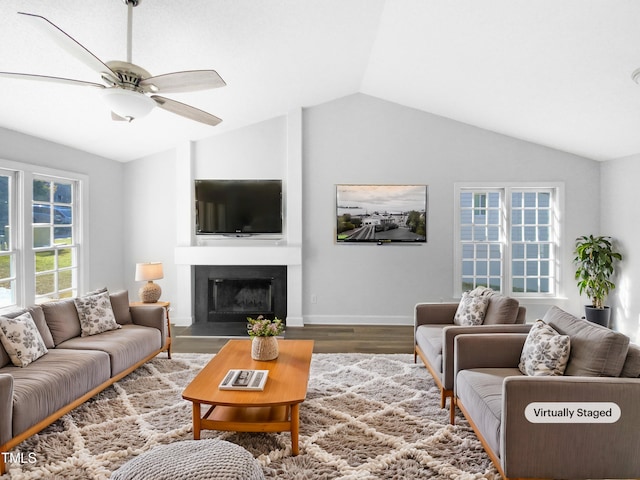 living room with ceiling fan, wood-type flooring, and vaulted ceiling