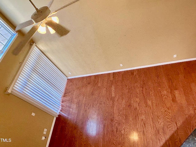 empty room with lofted ceiling and wood-type flooring