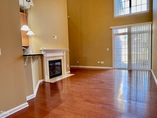 unfurnished living room featuring hardwood / wood-style flooring