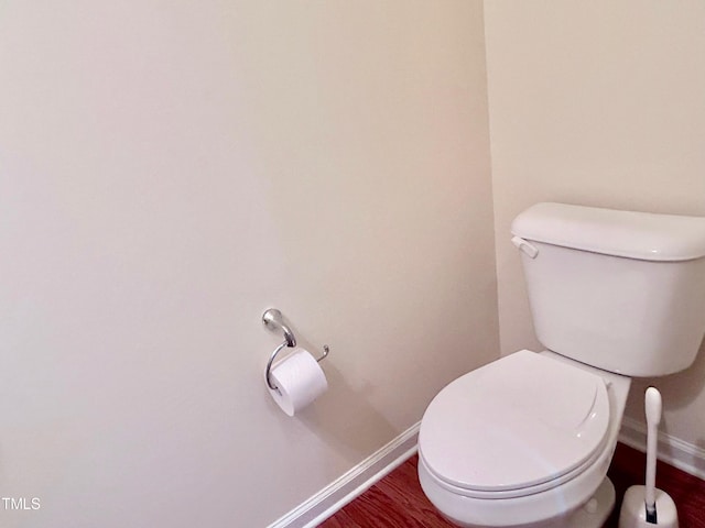 bathroom with toilet and hardwood / wood-style floors