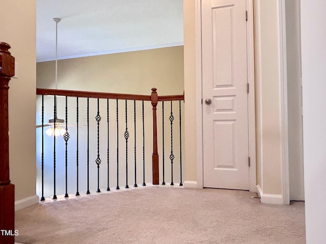 hall featuring light colored carpet