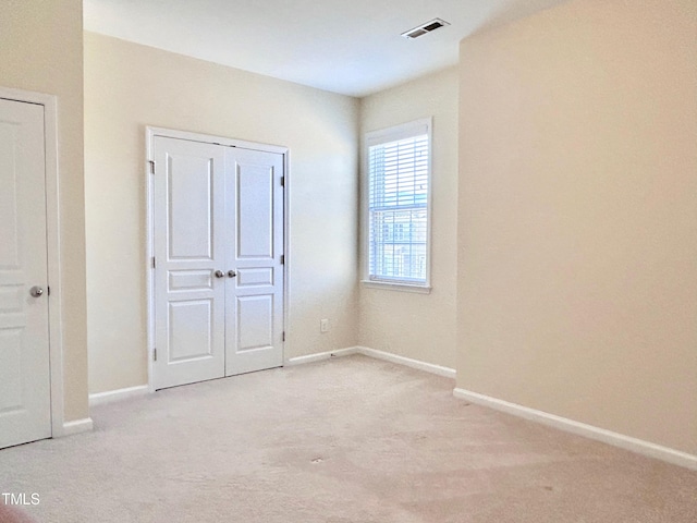 unfurnished bedroom with light colored carpet