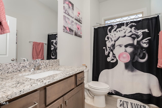 bathroom with vanity, a shower with curtain, toilet, and tile patterned flooring