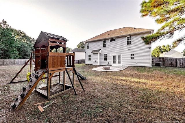 view of jungle gym featuring a patio area, central air condition unit, and a lawn