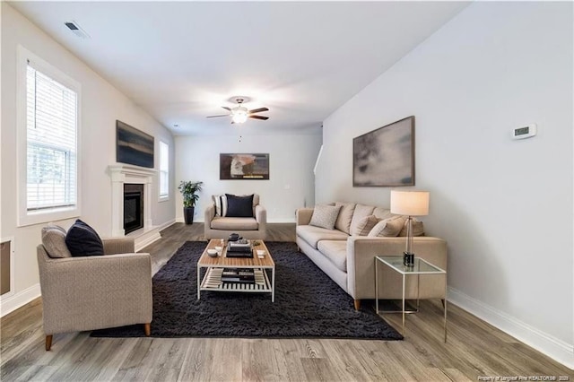 400 Jax Ct, Fayetteville, NC 28312 - living area with wood finished floors, a glass covered fireplace, baseboards, and ceiling fan