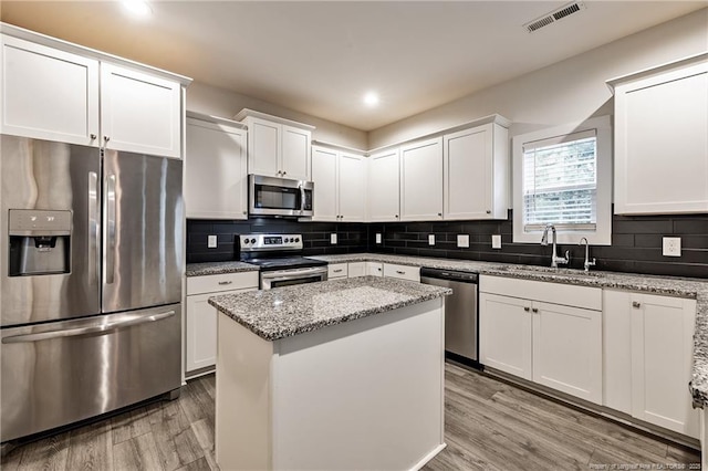 400 Jax Ct, Fayetteville, NC 28312 - kitchen with stainless steel appliances, a sink, light wood-style flooring, white cabinetry, and recessed lighting
