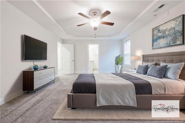 400 Jax Ct, Fayetteville, NC 28312 - bedroom featuring a raised ceiling, baseboards, carpet flooring, ensuite bath, and ceiling fan