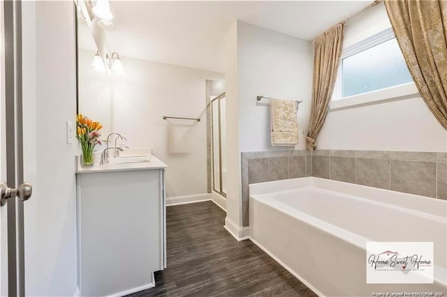 400 Jax Ct, Fayetteville, NC 28312 - full bath with a bath, vanity, a stall shower, wood finished floors, and baseboards