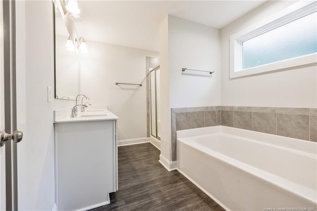 400 Jax Ct, Fayetteville, NC 28312 - bathroom with a garden tub, vanity, a stall shower, wood finished floors, and baseboards