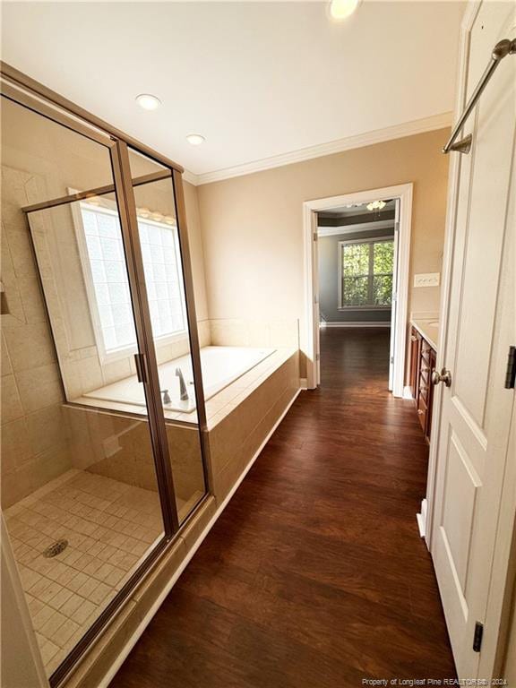 bathroom with ornamental molding, vanity, independent shower and bath, and hardwood / wood-style flooring