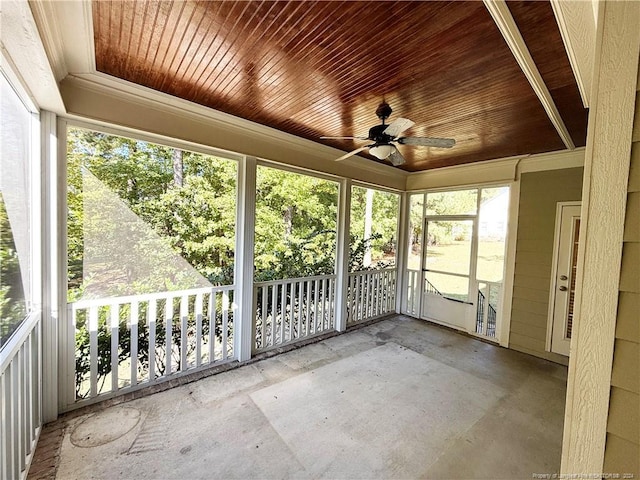 unfurnished sunroom featuring ceiling fan and wood ceiling