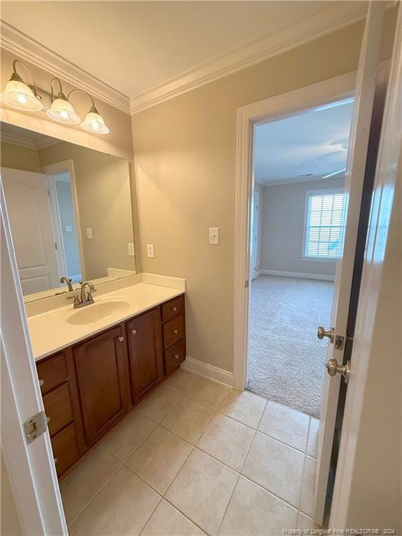 bathroom with tile patterned floors, vanity, and ornamental molding